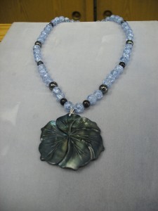 Custom Made Jewellry = 3. 1235- This is an unbelievable combination of 8mm round Blue-Violet crackle glass, Hematite, Blue goldstone beads make the large carved Mother of Pearl flower jump to life. It is so gorgeous and lively.